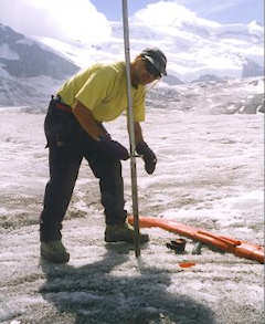 Drilling an observation stake for measuring glacier thickness