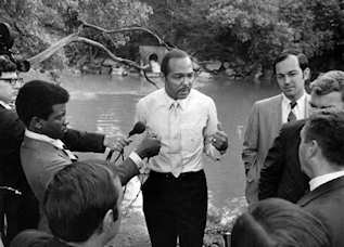 Cleveland Mayor Carl Stokes in front of the Cuyahoga River in 1969