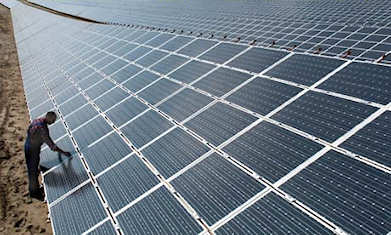 A worker tends to the world's largest solar plant in Germany. Photo: Waltraud Grubitzsch/EPA/Corbis