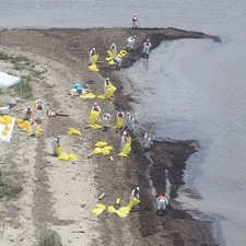 BEACH CLEAN-UP: Workers clean up oil along a beach at South Pass,
La. May 11, 2010 near where the the Mississippi River meets the Gulf of
Mexico.